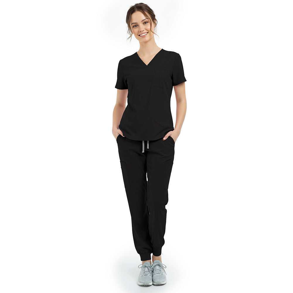 Front view of model with hands in pockets wearing Black scrubs, showing relaxed athletic fit
