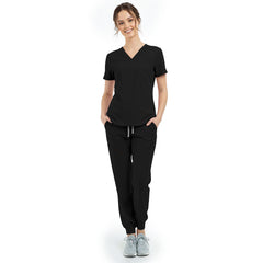 Front view of model with hands in pockets wearing Black scrubs, showing relaxed athletic fit