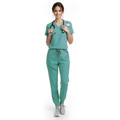 Dental hygienist wearing Turquoise performance scrubs ready for patient appointment