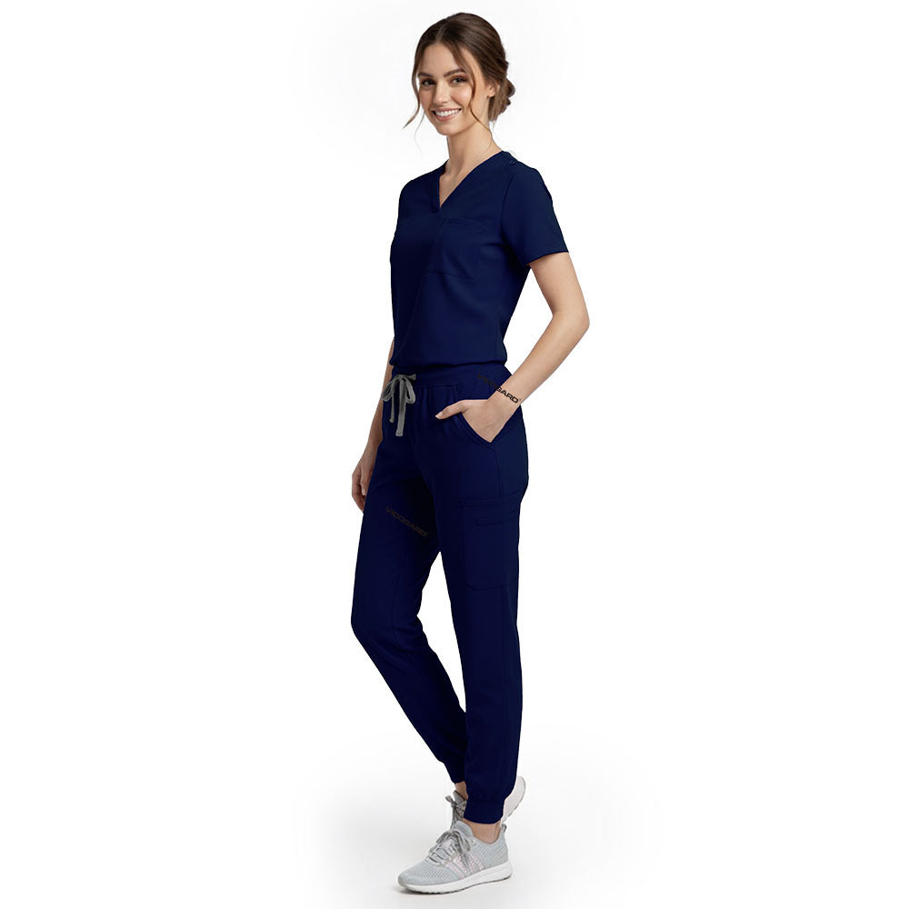 Side view of model using streamlined cargo pocket on Galaxy Blue scrub pants, showing non-bulky storage