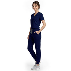 Side view of model using streamlined cargo pocket on Galaxy Blue scrub pants, showing non-bulky storage