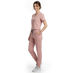 Side view of model using streamlined cargo pocket on Pink scrub pants, showing non-bulky storage