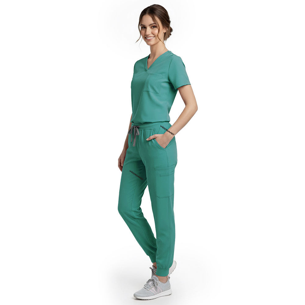 Side view of model using streamlined cargo pocket on Turquoise scrub pants, showing non-bulky storage