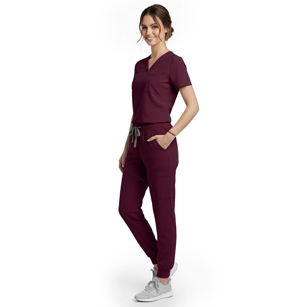 Side view of model using streamlined cargo pocket on Burgundy scrub pants, showing non-bulky storage
