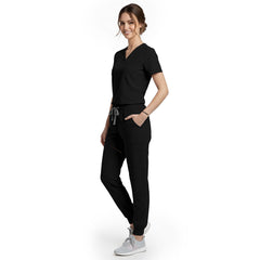 Side view of model using streamlined cargo pocket on Black scrub pants, showing non-bulky storage