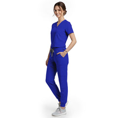 Side view of model using cargo pocket on Royal Blue scrub pants, showing streamlined storage