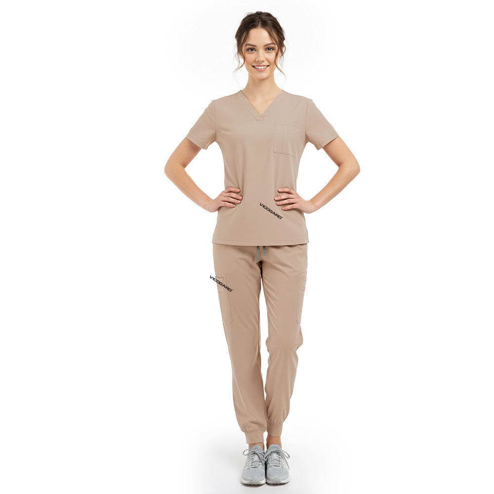 Model pose highlighting the tailored waist silhouette of the Apricot performance scrub top