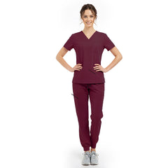 Model pose highlighting the tailored waist silhouette of the Burgundy performance scrub top
