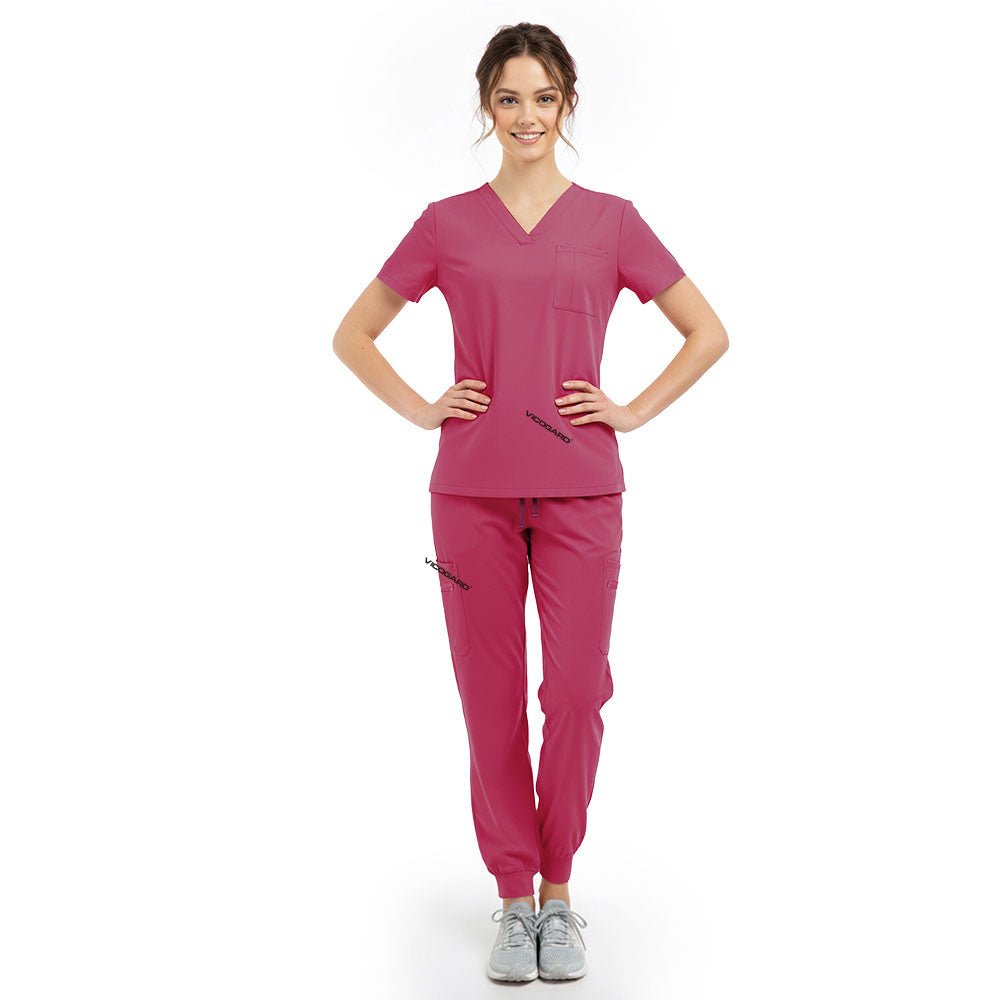 Model pose highlighting the tailored waist silhouette of the Rose Pink performance scrub top