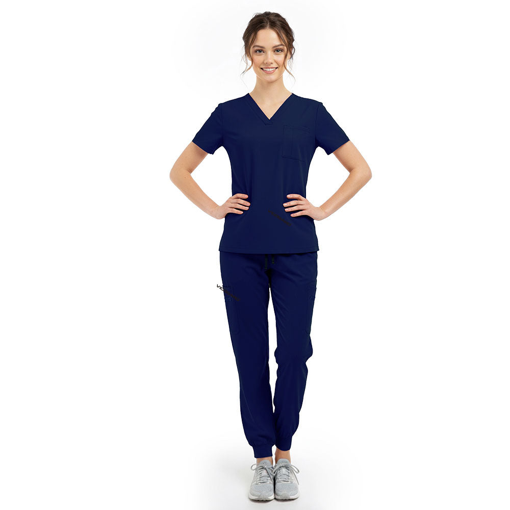 Model pose highlighting the tailored waist silhouette of the Galaxy Blue performance scrub top