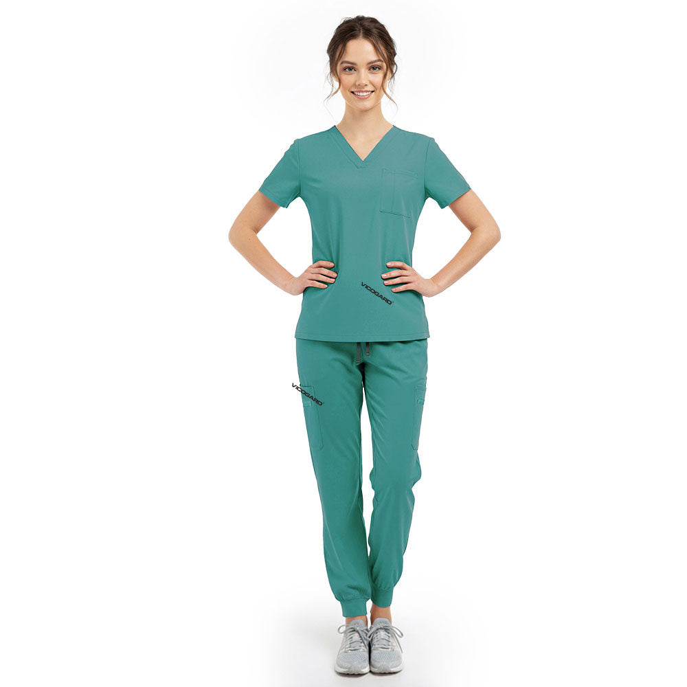 Model pose highlighting the tailored waist silhouette of the Turquoise performance scrub top