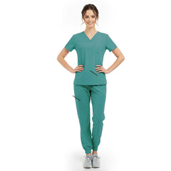 Model pose highlighting the tailored waist silhouette of the Turquoise performance scrub top