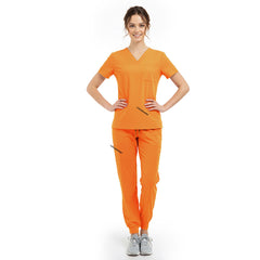 Model pose highlighting the tailored waist silhouette of the Mango Yellow performance scrub top
