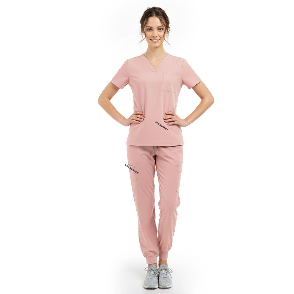 Model pose highlighting the tailored waist silhouette of the Pink performance scrub top