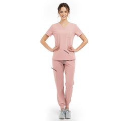 Model pose highlighting the tailored waist silhouette of the Pink performance scrub top