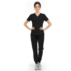 Model pose highlighting the tailored waist silhouette of the Black performance scrub top