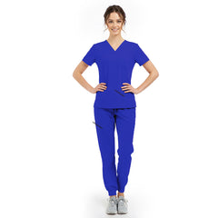 Model pose highlighting the tailored waist fit of the Royal Blue scrub top