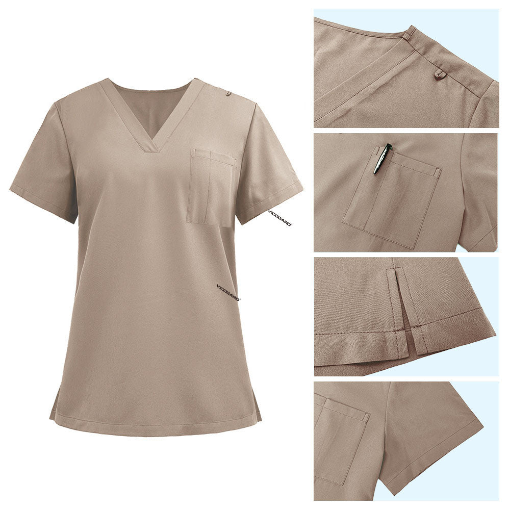 Detail of Apricot scrub top shoulder D-ring loop and minimalist chest pocket