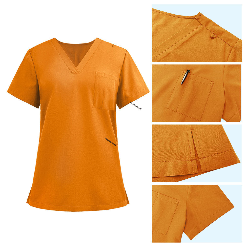 Detail of Mango Yellow scrub top shoulder D-ring loop and minimalist chest pocket
