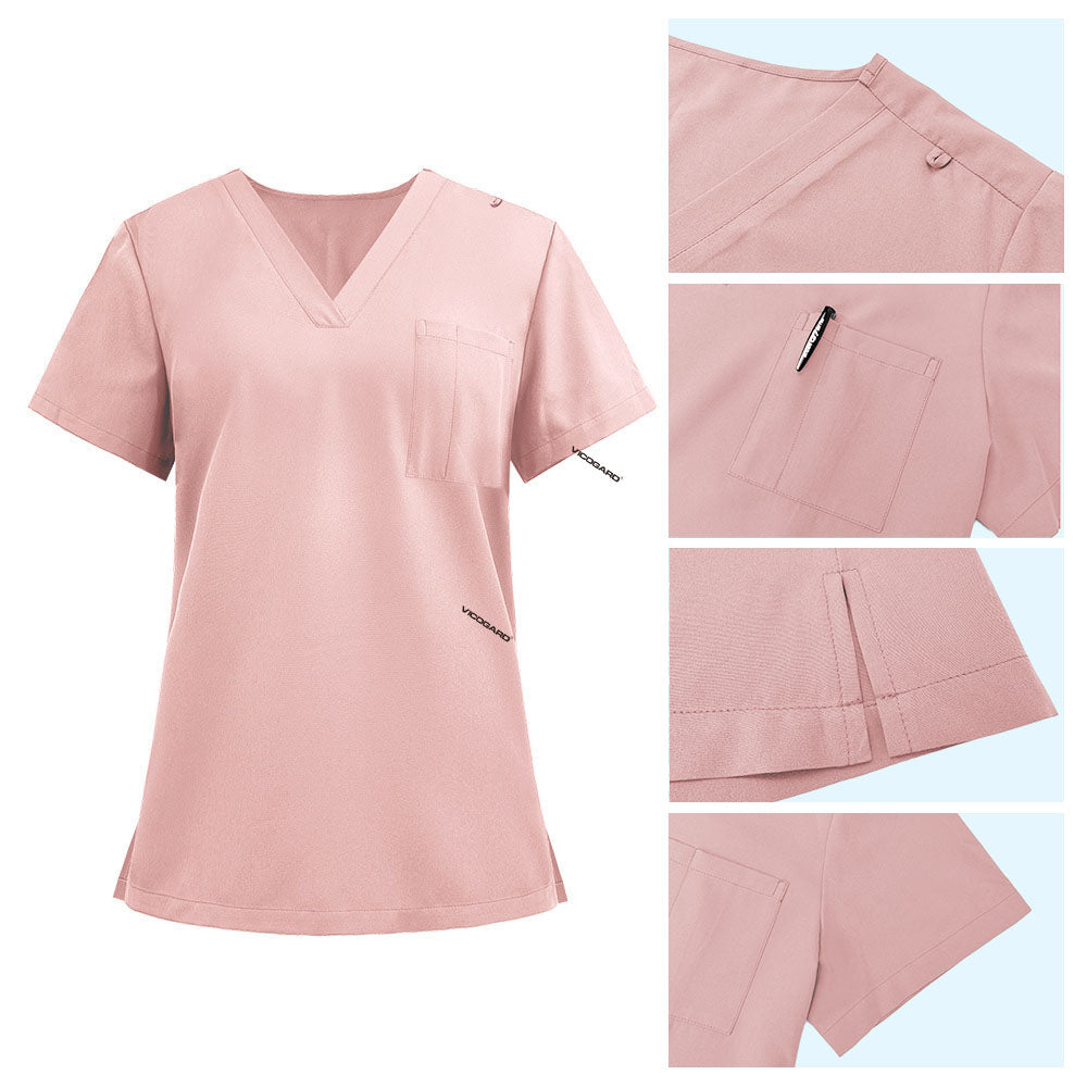 Detail of Pink scrub top shoulder D-ring loop and minimalist chest pocket