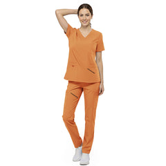 Front view of nurse walking in Orange straight leg scrubs, showing high visibility and 4-way stretch