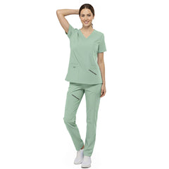 Front view of nurse walking in Avocado Green straight leg scrubs, showing comfortable fit and 4-way stretch