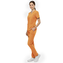 Side view of model using deep cargo pocket on Orange scrub pants, showing spacious storage for tools