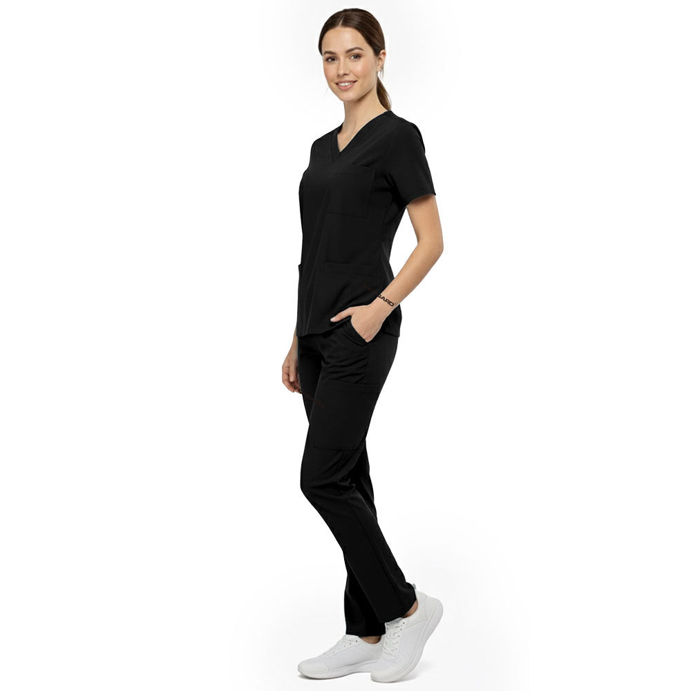 Side view of model using deep cargo pocket on Black scrub pants, showing spacious storage for beauty tools