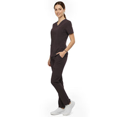 Side view of model using deep cargo pocket on Chocolate scrub pants, showing spacious storage