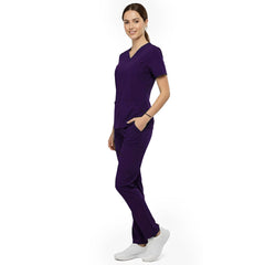Side view of model using deep cargo pocket on Grape scrub pants, showing spacious storage