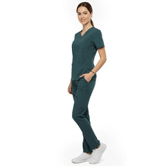 Side view of model using deep cargo pocket on Turquoise scrub pants, showing spacious storage for tools