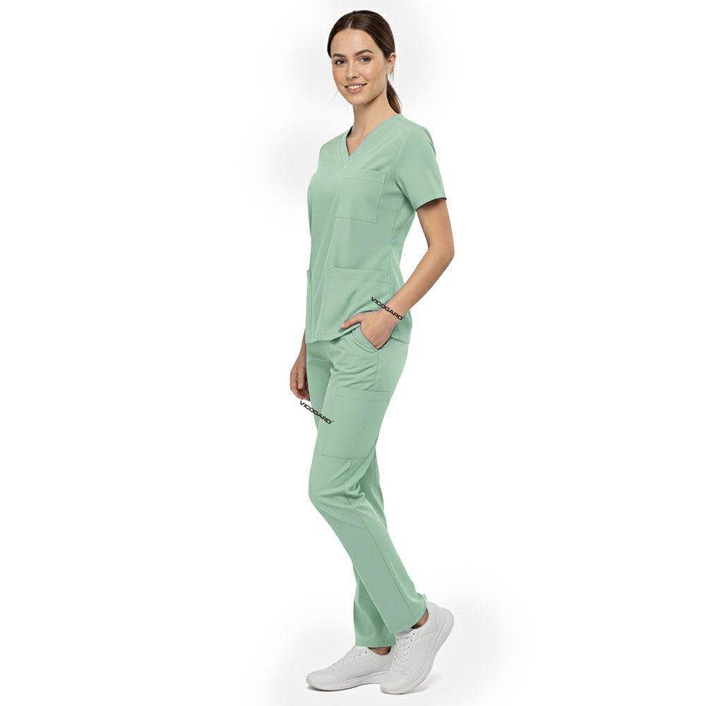 Side view of model using deep cargo pocket on Avocado Green scrub pants, showing spacious storage