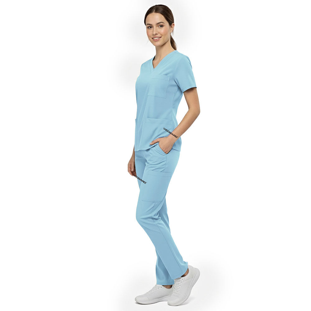 Side view of model using deep cargo pocket on Marine Blue scrub pants, showing spacious storage