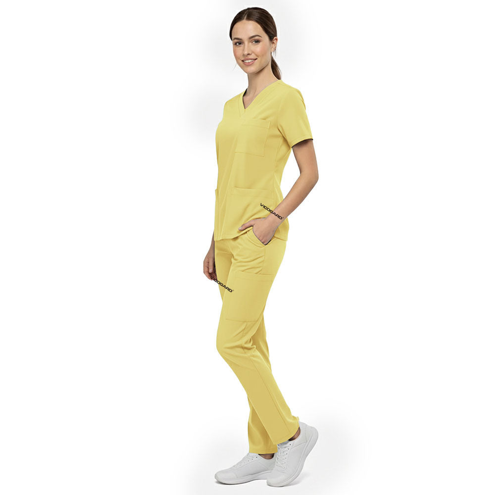 Side view of model using deep cargo pocket on Cream Yellow scrub pants, showing spacious storage