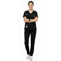 Esthetician wearing Black performance scrubs ready for client consultation in med spa