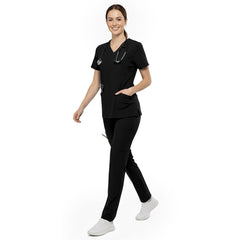 Professional reaching into chest pocket of Black V-neck scrub top, demonstrating easy access to pens