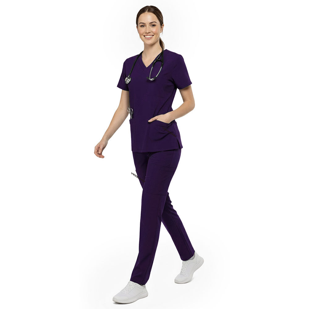 Professional reaching into chest pocket of Grape V-neck scrub top, demonstrating easy access