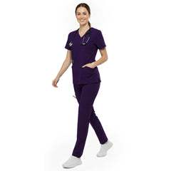 Professional reaching into chest pocket of Grape V-neck scrub top, demonstrating easy access