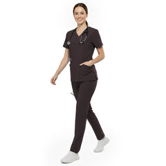 Professional reaching into chest pocket of Chocolate V-neck scrub top, demonstrating easy access