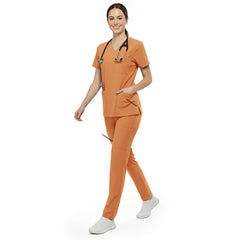 Nurse reaching into chest pocket of Orange V-neck scrub top, demonstrating easy access to essentials