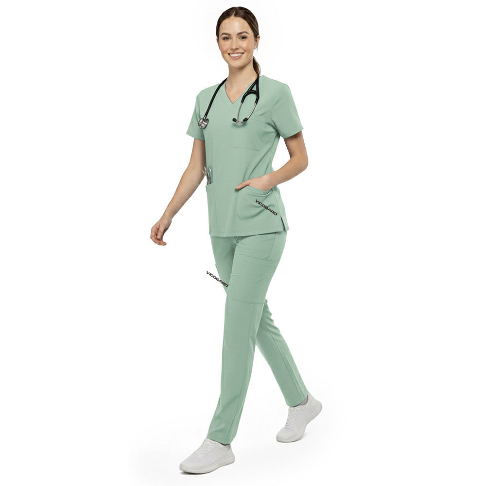 Professional reaching into chest pocket of Avocado Green V-neck scrub top, demonstrating easy access