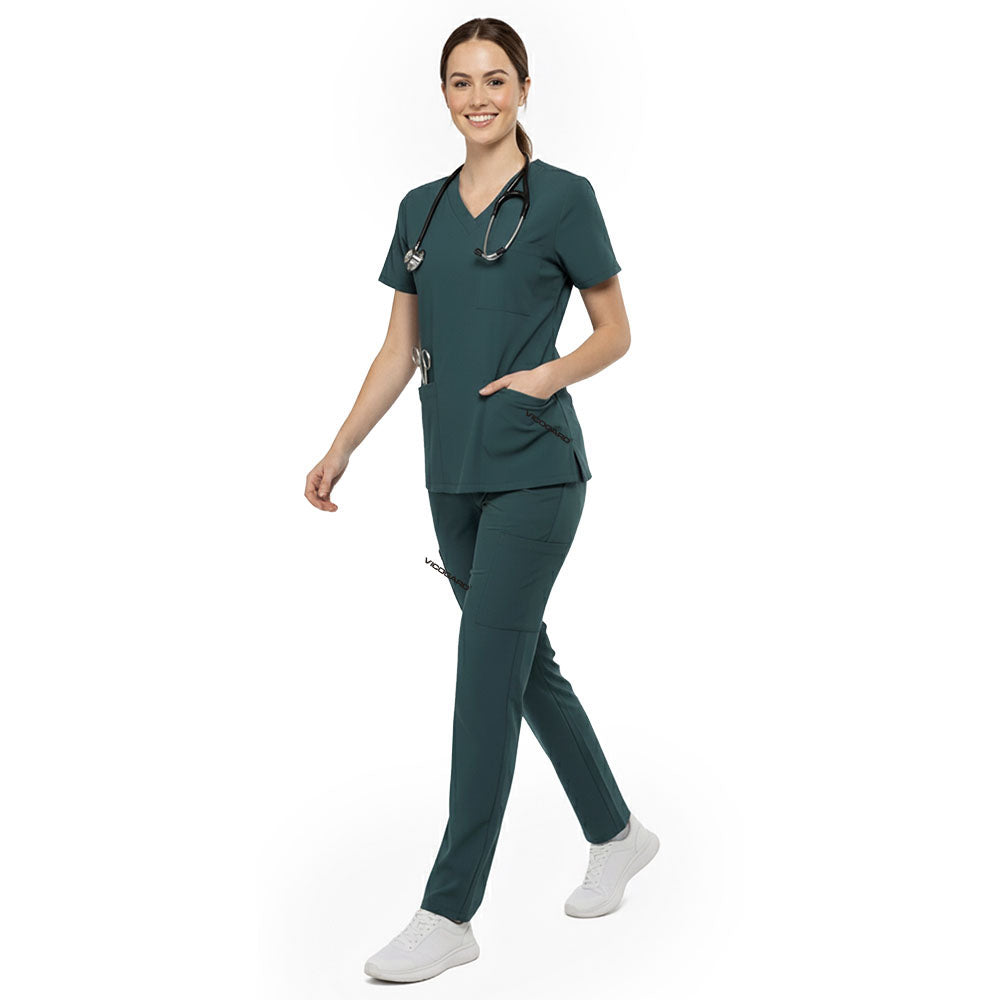 Hygienist reaching into chest pocket of Turquoise V-neck scrub top, demonstrating easy access