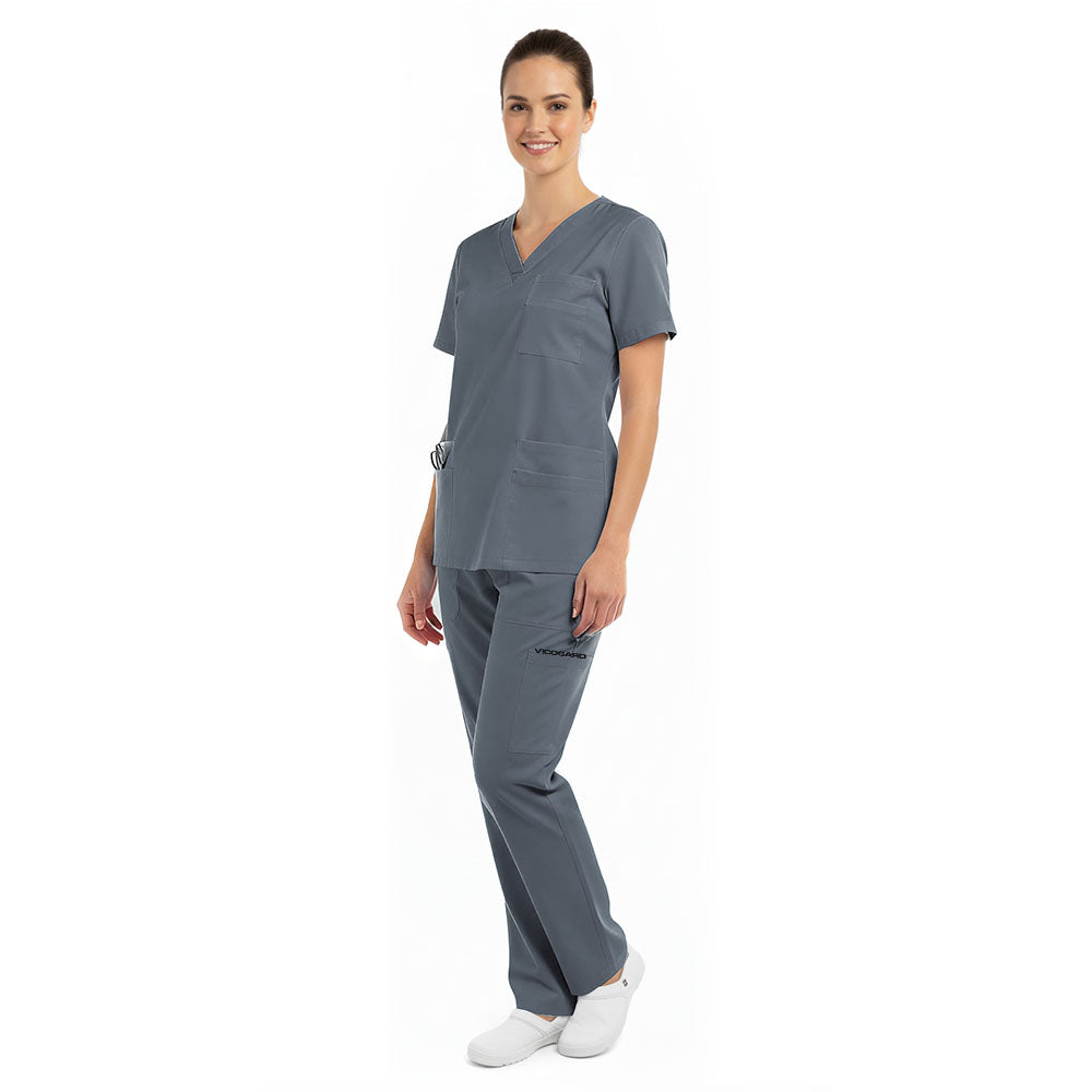 Side angle of model in Heather Gray Pro scrubs, showing pocket placement