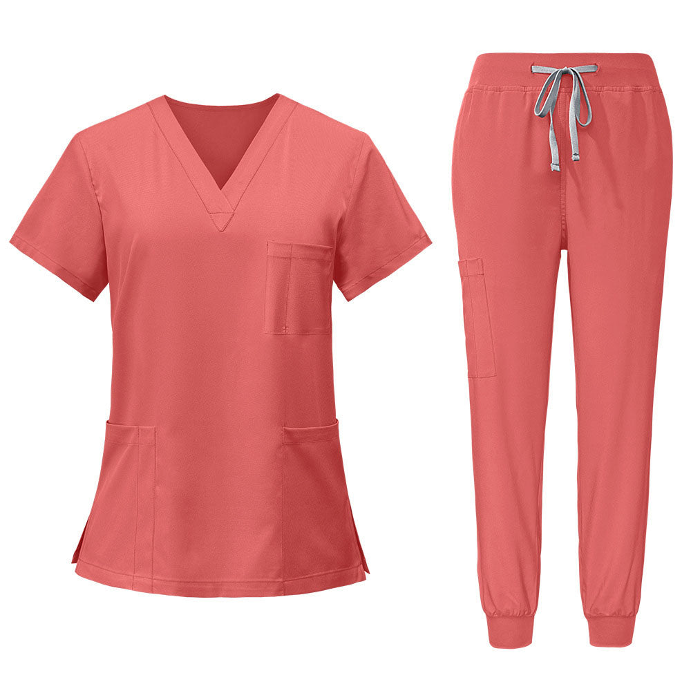 Flat lay of Orange Red scrub set featuring V-neck top and matching jogger pants