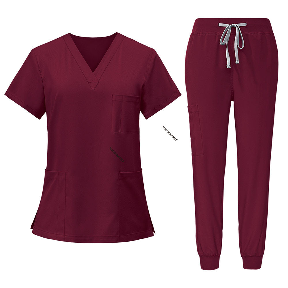 Flat lay of Burgundy scrub set featuring V-neck top and jogger pants