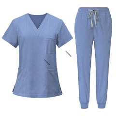 Flat lay of Ceil Blue scrub set featuring V-neck top and jogger pants