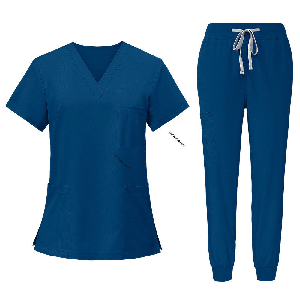 Flat lay of Caribbean Blue scrub set featuring V-neck top and jogger pants