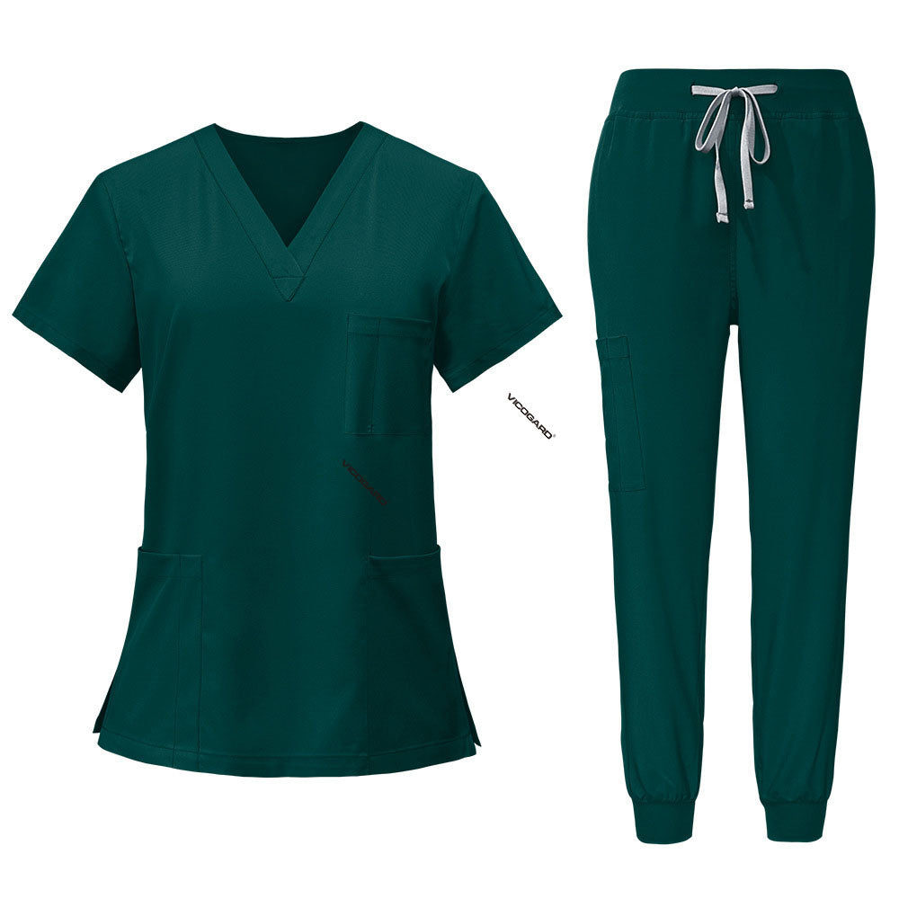 Flat lay of Hunter Green scrub set featuring V-neck top and jogger pants