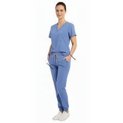 Nurse utilizing functional pockets on Vicogard Ceil Blue stretch scrub pants