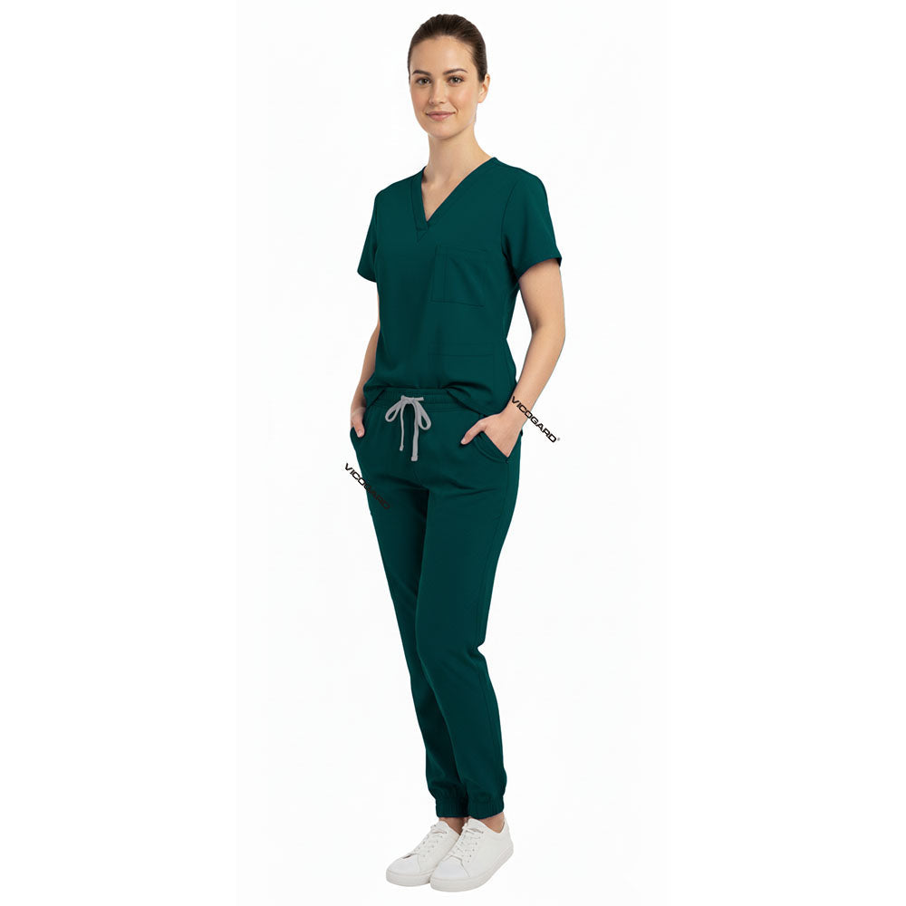 Medical professional utilizing functional pockets on Vicogard Hunter Green stretch scrub pants